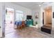 Bright living room features tile flooring, a dining table, and stylish turquoise console at 408 Middlestone Ave, Henderson, NV 89011
