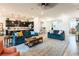 A living room view showcasing the open layout with the kitchen, sofas, rug and tile floors at 408 Middlestone Ave, Henderson, NV 89011