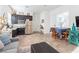 Living room featuring an open layout to the kitchen with tile flooring, an eat-in table and a comfortable sofa at 408 Middlestone Ave, Henderson, NV 89011