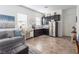 Living room featuring black cabinets, stainless steel appliances, a comfortable gray sofa and a modern design at 408 Middlestone Ave, Henderson, NV 89011
