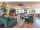 Bright living room with large TV, comfortable seating, and access to outdoor patio at 408 Middlestone Ave, Henderson, NV 89011