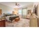 Spacious main bedroom with a decorative ceiling fan, plush rug, and elegant furnishings at 408 Middlestone Ave, Henderson, NV 89011