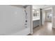 Bathroom with gray cabinets, large mirror, walk-in shower with white tiling and dark fixtures at 45 Maleena Mesa St # 1113, Henderson, NV 89074