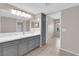 Bathroom features a large mirror, gray cabinets, and double sinks at 45 Maleena Mesa St # 1113, Henderson, NV 89074
