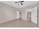 Bright bedroom features neutral walls, ceiling fan and tile floors that lead to an adjoining bathroom at 45 Maleena Mesa St # 1113, Henderson, NV 89074