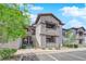 Condo with tan exterior, staircase, covered balcony, and lovely landscaping around the building at 45 Maleena Mesa St # 1113, Henderson, NV 89074