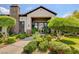 Inviting front entrance with lush landscaping, a stone accent wall, and a welcoming walkway at 45 Maleena Mesa St # 1113, Henderson, NV 89074