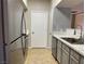 Modern kitchen with stainless steel appliances, light gray cabinets, and tile backsplash at 45 Maleena Mesa St # 1113, Henderson, NV 89074