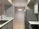 Kitchen area features stainless appliances, gray cabinets, stone countertops and a backsplash at 45 Maleena Mesa St # 1113, Henderson, NV 89074