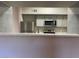 Open kitchen features stainless appliances, tile backsplash, and breakfast bar at 45 Maleena Mesa St # 1113, Henderson, NV 89074