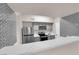 Open kitchen features stainless appliances, gray cabinets, stone countertops, and tile backsplash at 45 Maleena Mesa St # 1113, Henderson, NV 89074