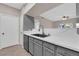 This kitchen features stainless appliances, white countertops, gray cabinets, and tile backsplash at 45 Maleena Mesa St # 1113, Henderson, NV 89074