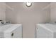 Bright laundry room featuring white washer and dryer appliances and wire shelving at 45 Maleena Mesa St # 1113, Henderson, NV 89074