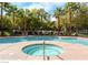 Community pool area with a hot tub, comfortable lounge chairs, and palm trees, perfect for relaxation at 45 Maleena Mesa St # 1113, Henderson, NV 89074