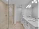 Modern bathroom with a double vanity, glass-enclosed shower, and neutral tile at 4525 Dean Martin Dr # 3006, Las Vegas, NV 89103