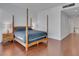Comfortable bedroom with a four-poster bed, side table, and hardwood floors at 4525 Dean Martin Dr # 3006, Las Vegas, NV 89103