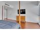 A modern bedroom showcasing hardwood floors, a flat-screen TV, and minimalist decor at 4525 Dean Martin Dr # 3006, Las Vegas, NV 89103