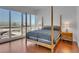 Bright bedroom with hardwood floors and a four-poster bed boasting city views through large windows at 4525 Dean Martin Dr # 3006, Las Vegas, NV 89103