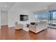 Spacious living room with floor-to-ceiling windows, sleek hardwood floors, and stylish contemporary furniture at 4525 Dean Martin Dr # 3006, Las Vegas, NV 89103