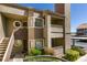 Attractive condo featuring a private balcony, beautiful landscaping, and convenient covered parking at 5032 S Rainbow Blvd # 206, Las Vegas, NV 89118