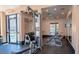 Bright gym with a range of weight machines, a mirror, and an exit door near the community pool at 5032 S Rainbow Blvd # 206, Las Vegas, NV 89118