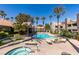 Community pool and spa surrounded by lush landscaping, perfect for relaxation and recreation at 5032 S Rainbow Blvd # 206, Las Vegas, NV 89118