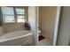 Bright bathroom featuring a tub with windows and a separate toilet area at 5615 Oak Bend Dr, Las Vegas, NV 89135