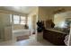 Primary bathroom featuring a soaking tub, stand up shower, and a sink at 5615 Oak Bend Dr, Las Vegas, NV 89135