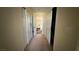 Hallway with carpet and multiple closet doors leading to the Primary bedroom at 5615 Oak Bend Dr, Las Vegas, NV 89135