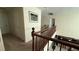 Upstairs hallway featuring dark wood railing and neutral colored carpet at 5615 Oak Bend Dr, Las Vegas, NV 89135