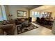 Comfortable living room with tile flooring, large windows, and a view into the dining area at 5615 Oak Bend Dr, Las Vegas, NV 89135