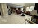 Spacious living room with tile flooring, high ceilings, and a seamless flow to the kitchen at 5615 Oak Bend Dr, Las Vegas, NV 89135