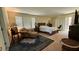 Carpeted main bedroom with a comfy seating area and sliding door at 5615 Oak Bend Dr, Las Vegas, NV 89135