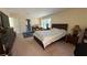 Carpeted main bedroom with a large bed and neutral colored walls at 5615 Oak Bend Dr, Las Vegas, NV 89135