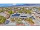 Aerial view of a home with solar panels, landscaped yard, long driveway and a private pool at 5892 Castleberry Peak Ave, Las Vegas, NV 89131
