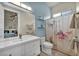 Bright bathroom featuring a single sink vanity and butterfly-themed shower curtain at 5892 Castleberry Peak Ave, Las Vegas, NV 89131