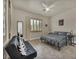 Neutrally decorated bedroom with queen bed, ceiling fan, and window with shutters at 5892 Castleberry Peak Ave, Las Vegas, NV 89131