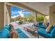 Comfortable covered patio with plush seating and views of the beautifully landscaped backyard at 5892 Castleberry Peak Ave, Las Vegas, NV 89131