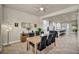 Open dining area with natural light, leading to a modern white kitchen at 5892 Castleberry Peak Ave, Las Vegas, NV 89131