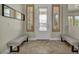Entrance foyer with decorative front door, tiled floors, and bench seating at 5892 Castleberry Peak Ave, Las Vegas, NV 89131