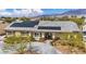 Charming single-story home featuring desert landscaping and solar panels at 5892 Castleberry Peak Ave, Las Vegas, NV 89131