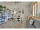 Bright home office with large desk, white bookshelves, and modern decor at 5892 Castleberry Peak Ave, Las Vegas, NV 89131
