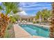 Inviting backyard pool and lounge area surrounded by lush landscaping, perfect for relaxing at 5892 Castleberry Peak Ave, Las Vegas, NV 89131