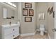 Well-lit powder room featuring stylish vanity, decorative art, and modern fixtures at 5892 Castleberry Peak Ave, Las Vegas, NV 89131