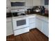 Functional kitchen featuring white appliances and granite countertops at 609 Marcella Ave, North Las Vegas, NV 89030