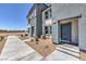 Inviting townhome entrance with a well-maintained walkway and modern architectural details at 6108 Aster Garden St # 130, North Las Vegas, NV 89081