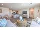 Open-concept living space with dining area and modern kitchen with seating at 6108 Aster Garden St # 130, North Las Vegas, NV 89081
