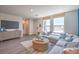 Inviting living room with ample natural light and stylish furnishings in a modern townhome at 6108 Aster Garden St # 130, North Las Vegas, NV 89081