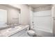 Standard bathroom with granite counters, a framed mirror, and shower-tub combination at 6164 Violet Falls St # 44, North Las Vegas, NV 89081