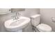 Bathroom features a pedestal sink, toilet, and neutral paint at 6164 Violet Falls St # 44, North Las Vegas, NV 89081